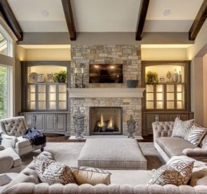 Beautifully decorated living room with a lit fireplace.
