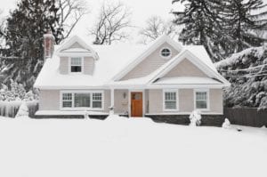Front exterior of a home that is covered in snow.