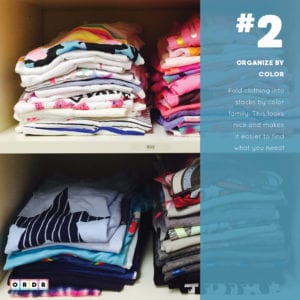 Shirts organized by color in a closet.