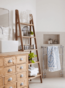 Ladder used as storage space in a bathroom.
