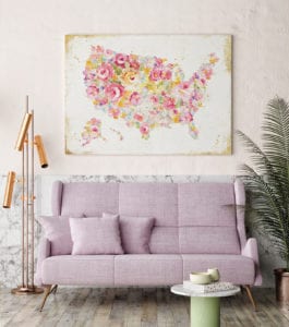Millennial pink couch with a pink abstract painting of the US behind it.