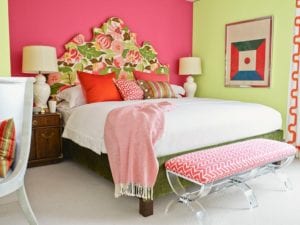 Bedroom with a millennial pink accent wall.