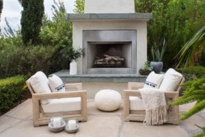 Patio furniture by an outdoor fire place
