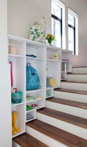 Stairwell with organized cabinets on one side.