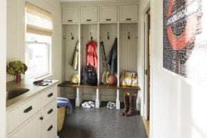 mudroom organized with sports equipment