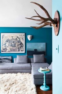 Room decorated with peacock blue embracing fall design trend.