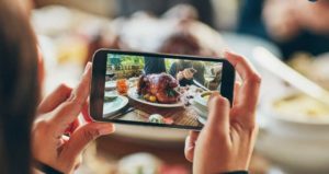 Person taking a picture of a thanksgiving turkey