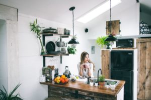Woman sitting in a small, stylish kitchen