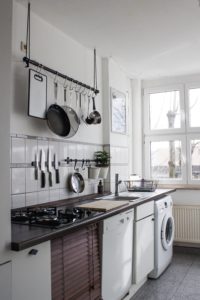 Kitchen with organized hanging pots and pans