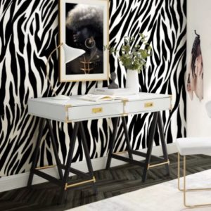Zebra print accent wall with small desk in front