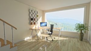 Modern home office with a large window overlooking the mountains