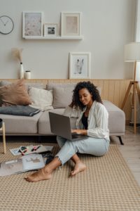 Woman sitting on the floor working from home