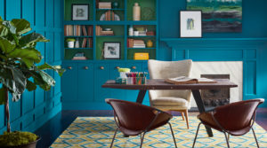Elegant study with vibrant blue wall and cabinet color