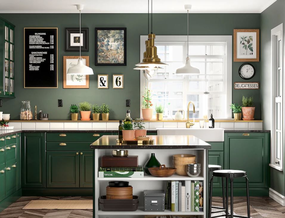 Green kitchen with white counter top and gold and white accents